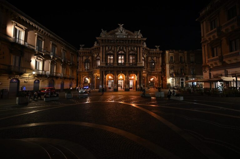 Catania city hall on Piazza Università illuminated at night — the anchor square of Catania nightlife