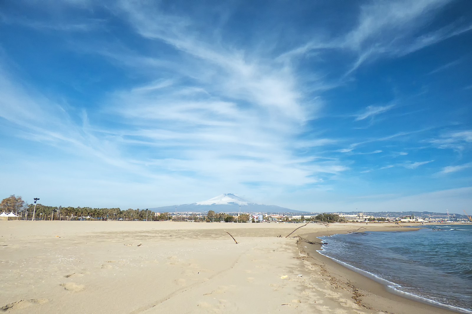 La Playa beach in Catania with Mount Etna in the background — setting for summer beach-club nightlife