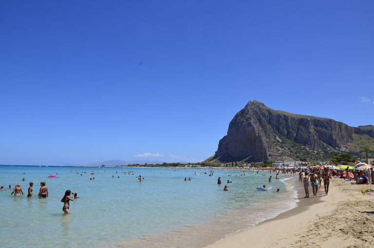 San Vito Lo Capo beach with white sand and clear blue water, Monte Monaco cliff in the background, Sicily