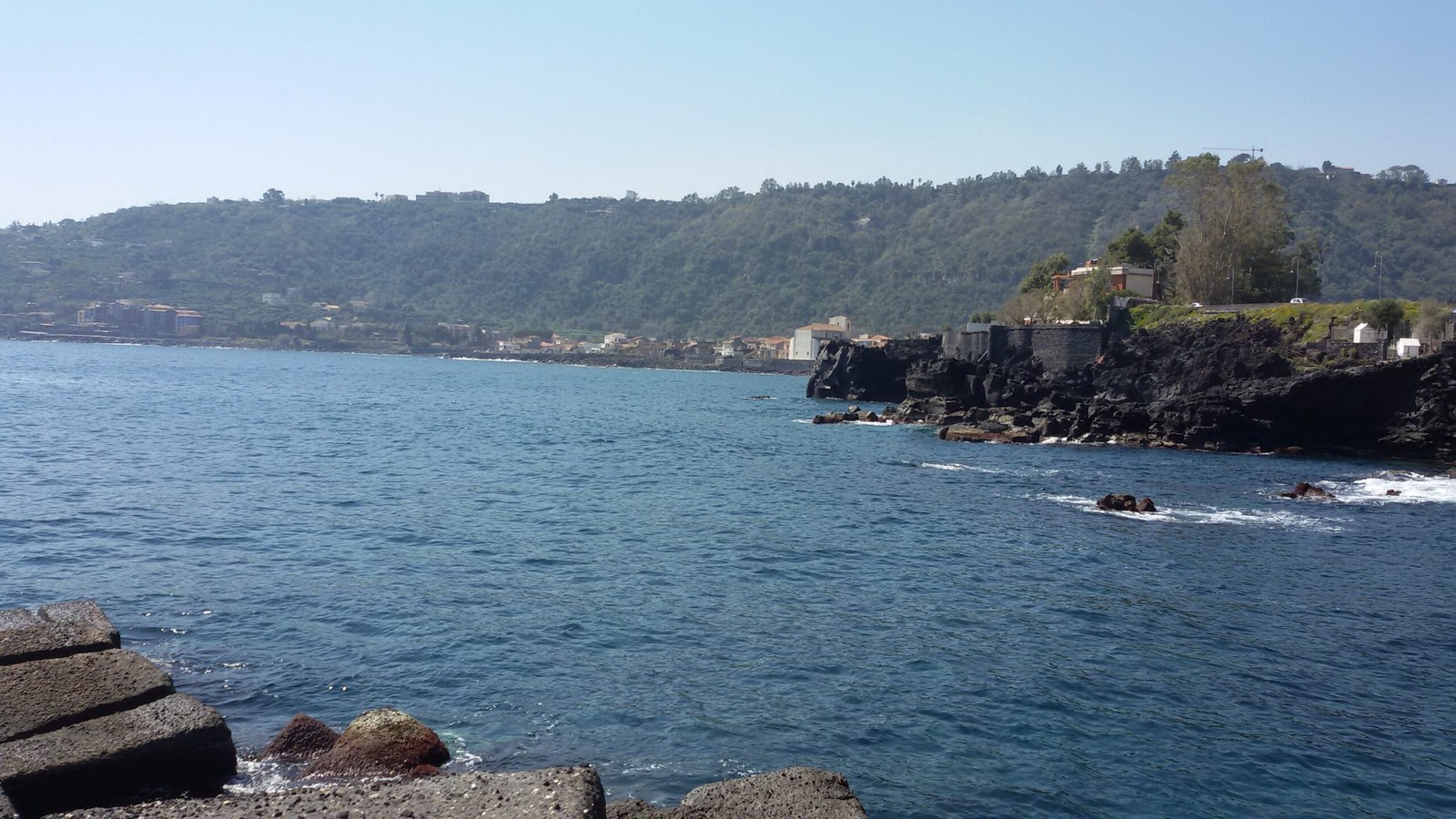 Acireale beaches: the Timpa di Santa Tecla lava cliff seen from the sea