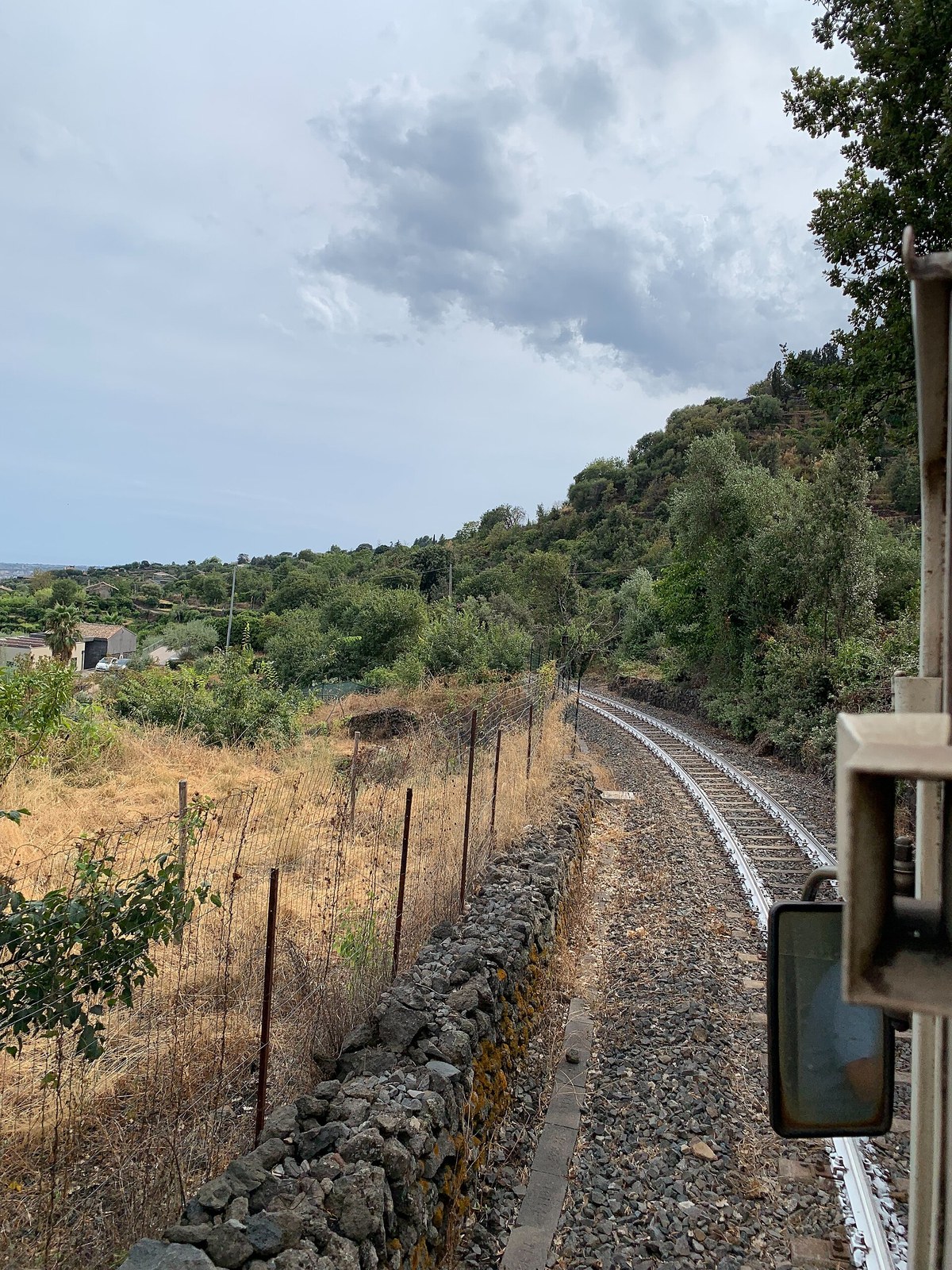 Ferrovia Circumetnea narrow-gauge railway train passing Mount Etna — Sicily wine train scenic route