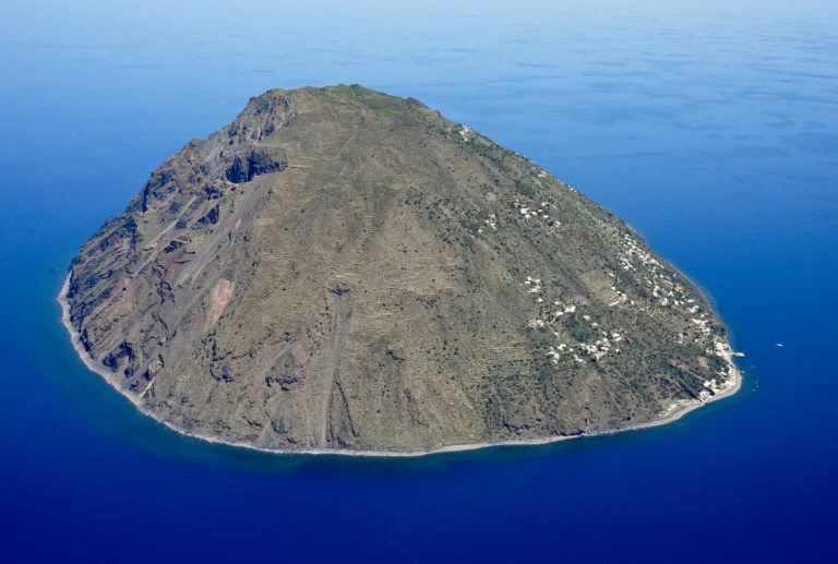 Aerial view of Alicudi island in the Aeolian Islands, Sicily, from the south, showing the volcanic cone and rocky coastline