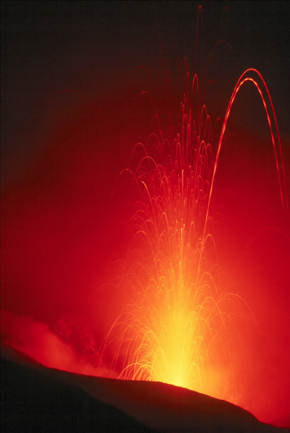 Strombolian eruption from Stromboli volcano — Aeolian Islands evening lava bursts visible at sea every 10-20 minutes during August