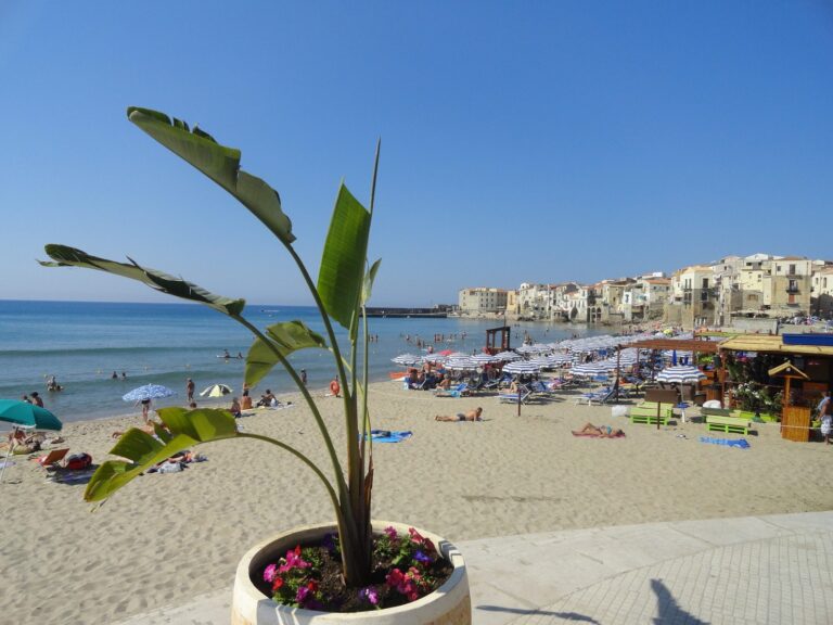 Cefalu sandy beach with old houses on the seafront, Sicily, ideal family holiday destination
