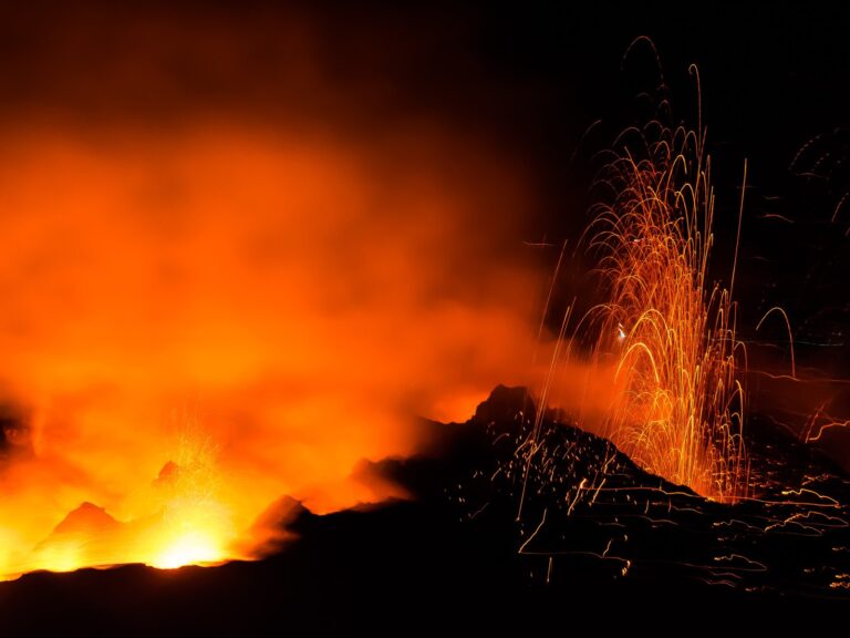 Italy honeymoon: Stromboli volcano in the Aeolian Islands erupting at night with glowing red lava — the most romantic unconventional Italian island