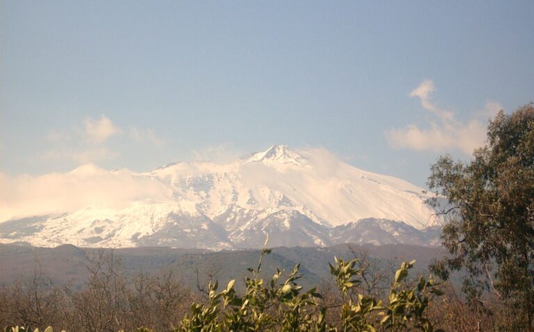 Mount Etna covered in snow under winter sky in Sicily — January ski season at the only Italian volcano where you can ski with sea view