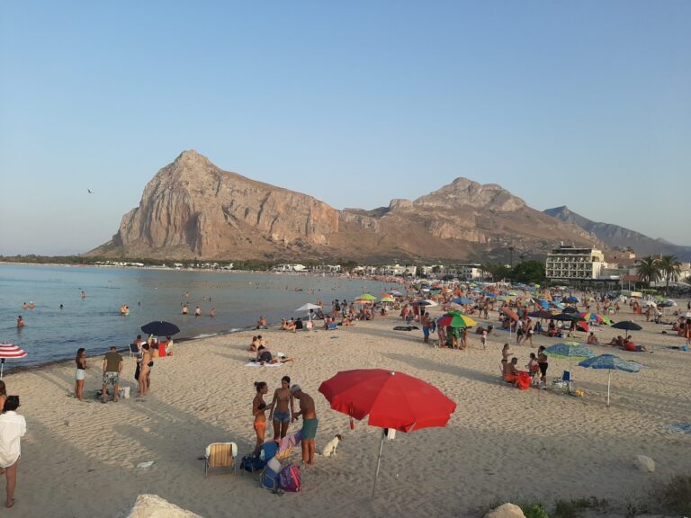 Beach of San Vito Lo Capo in Sicily with sun umbrellas and Monte Monaco in the background -- Couscous Fest venue and 3 km white-sand beach