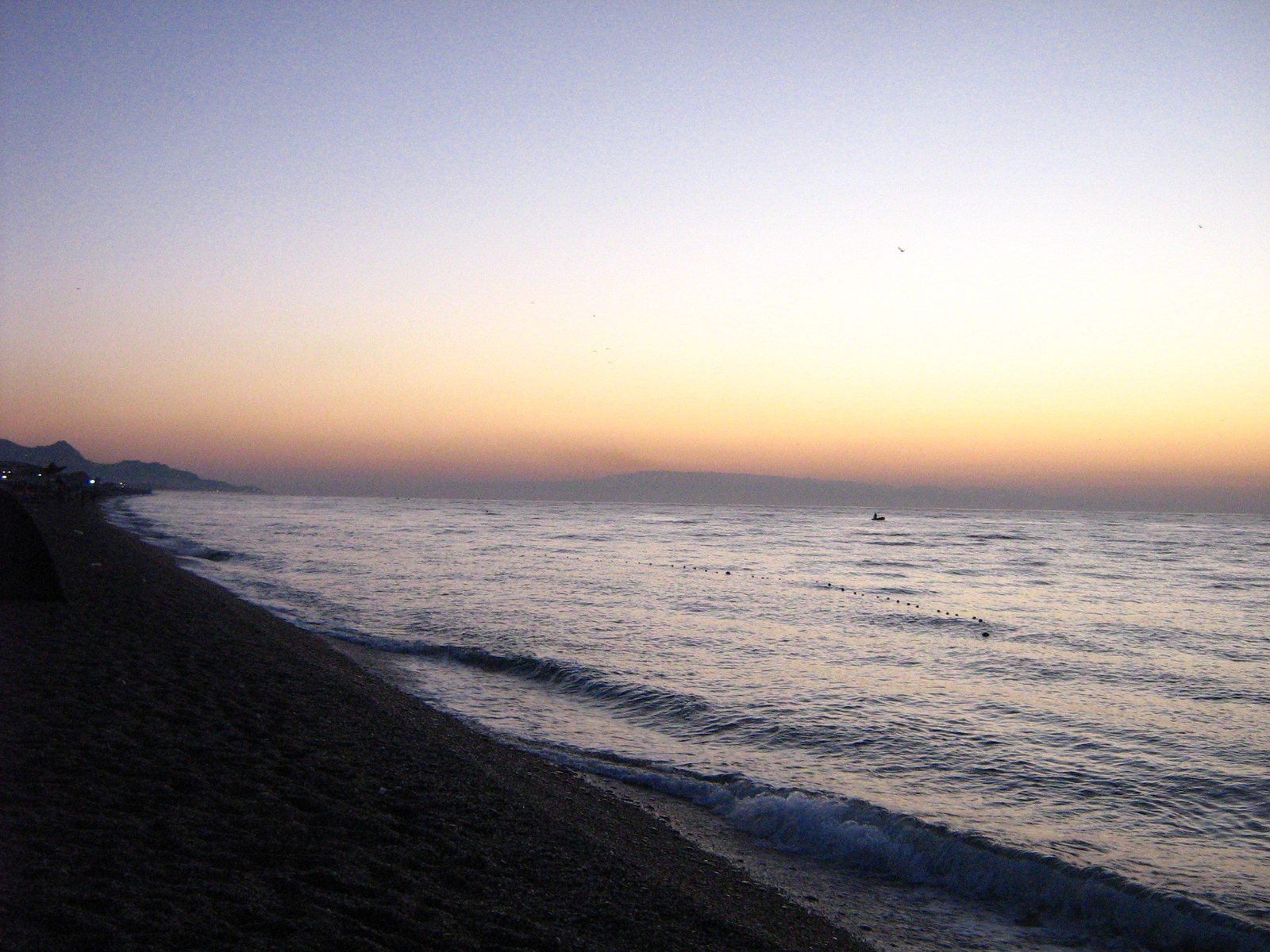 Fondachello beach near Catania: dark sand and Mount Etna view