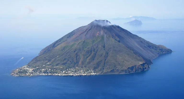 Aerial view of Stromboli island in the Aeolian Islands, Sicily, with Sciara del Fuoco visible on the right and Panarea on the horizon