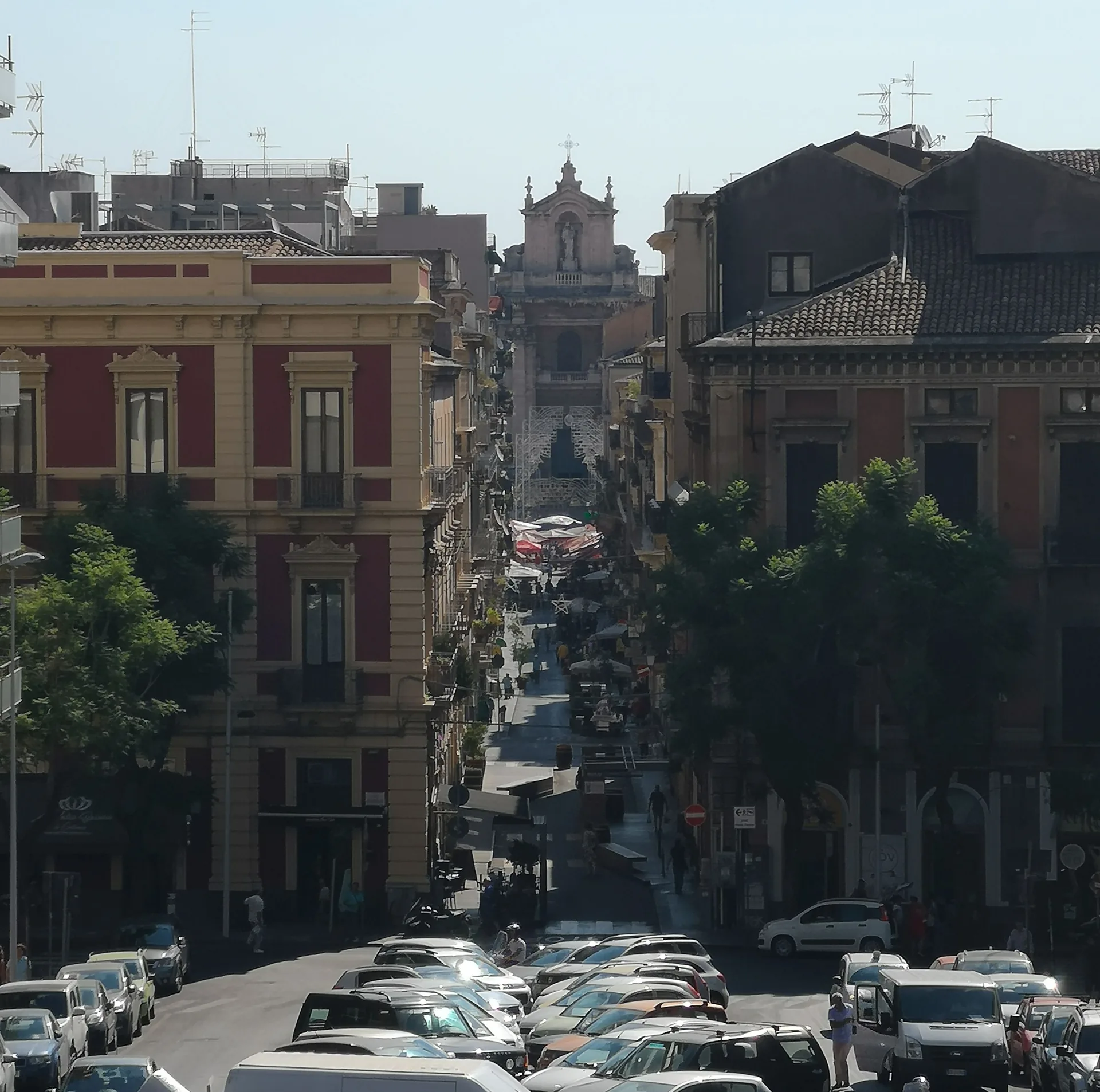 Cars parked along a narrow street in central Catania, Sicily